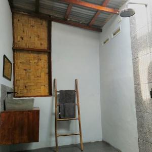 a room with a ladder and a white wall at Gino's Place - Bungalows and Restaurant in Bukit Lawang