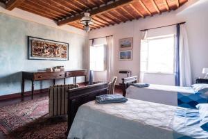 a bedroom with two beds and a desk at Villa Ott in Crespina +95 photos