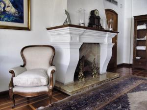 a chair in a living room with a fireplace at Solar De La Plaza in Salta