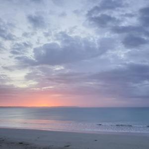 a sunset on a beach with a sky background at Cape Bridgewater Seaview Lodge in Cape Bridgewater