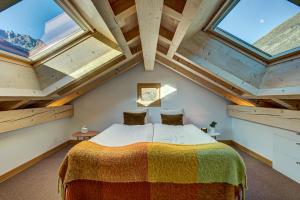 a bedroom with a bed in a room with skylights at Villa Mont Blanc in Chamonix-Mont-Blanc