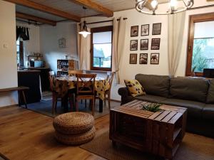 a living room with a couch and a table at Cicho Cichuteńko in Narew