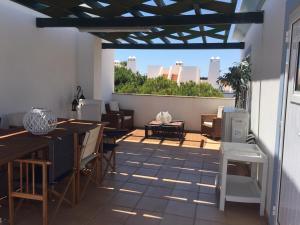 een patio met een tafel en stoelen en een raam bij Garden Villa, Cosy House by the sea in Praia Verde