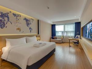 Ένα ή περισσότερα κρεβάτια σε δωμάτιο στο Kyriad Hotel Leiyang West Lake Amusement Park +14 φωτογραφίες