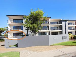 a large apartment building with an orange circle on it at Illawong 4 in Mooloolaba