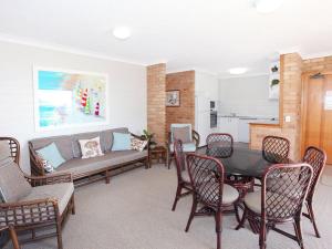 a living room with a table and chairs and a couch at Illawong 4 in Mooloolaba