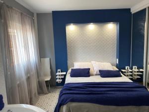 a blue bedroom with a bed with two blue pillows at Casa Rural Aguachales in Villanueva-Matamala