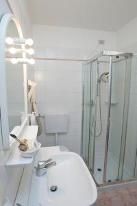 a bathroom with a sink and a glass shower at Hotel Ristorante Alla Botte in Portogruaro