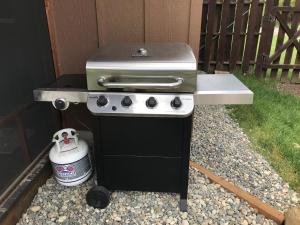 an outdoor grill with a stove in a backyard at Reedy Set Go! by Casago McCall - Donerightmanagement in McCall