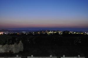 a view of a city at night with lights at Villa Panorama in Moúdhros