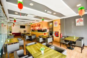a restaurant with tables and chairs and a bar at Ritz Suites in Lumut