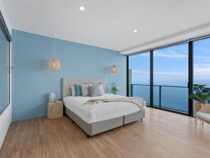a bedroom with a bed with a view of the ocean at Circle on Cavill - GCLR in Gold Coast