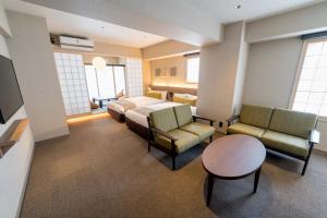 a hospital room with a bed and chairs and a table at RESI STAY Hotel SUN CHLORELLA in Kyoto