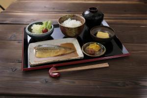 a tray of food with chopsticks and bowls of food at HOTEL ZEN Yokohama Hazawa in Yokohama