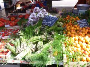 a display of vegetables and fruits in a market at Hotel Rossetti in Nice