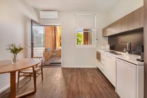 a kitchen with a table and a dining room at Langsford Luxury in Stawell