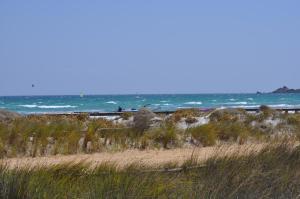 a sandy beach with the ocean in the background at Villa Panorama in Moúdhros