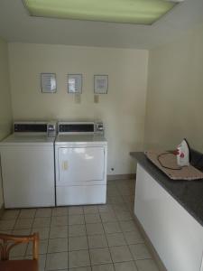 a kitchen with white appliances and a counter top at Red Carpet Inn Syracuse Airport in North Syracuse