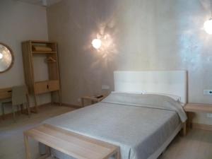 a bedroom with a bed and a table in it at Hotel Rossetti in Nice