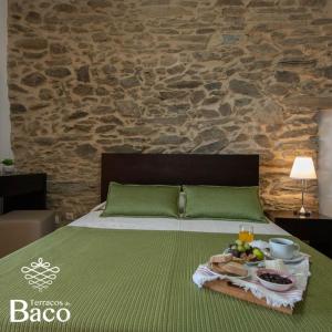 a green bed with a tray of food on it at Terraços de Baco in Ribalonga +18 photos