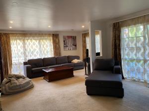 a living room with a couch and a table at ADA Homestay in Doncaster