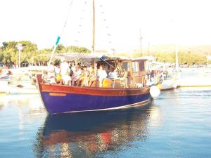 a group of people on a boat in the water at Villa Panorama in Moúdhros
