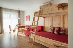 a bedroom with a wooden bunk bed with a ladder at Landhaus am Gries in Lana