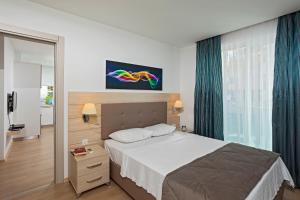 a bedroom with a bed and a large window at The Room Hotel & Apartments in Antalya
