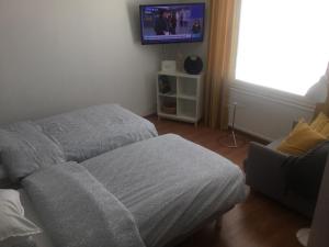 a bedroom with two beds and a tv on the wall at Two bedroom apartment with view to the sea Free parking in Kemi