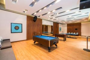 a room with a pool table and several tables at NH Collection Samui Peace Resort in Bophut