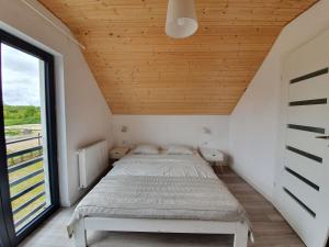 Säng eller sängar i ett rum på Domki Białe Żagle