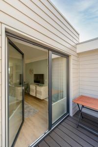 a sliding glass door on a patio with a table at Nordsee-Ferienwohnungen Hinrichsen in Husum