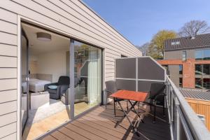a balcony with a table and chairs on a house at Nordsee-Ferienwohnungen Hinrichsen in Husum +37 photos