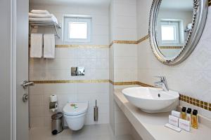 a bathroom with a sink and a toilet and a mirror at The Room Hotel & Apartments in Antalya +37 photos