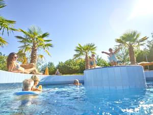a group of people in the water at a swimming pool at Ferienwohnung Wandl in Bad Griesbach