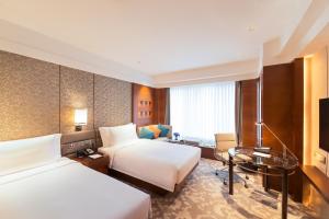 Voodi või voodid majutusasutuse Crowne Plaza Macau by IHG toas