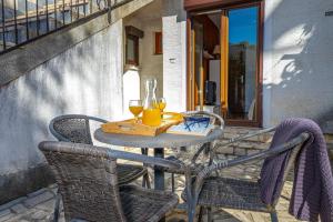 a table with two glasses of wine on a patio at Apartmani Pilaš in Dramalj