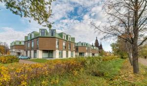 a building with a green roof on a city street at New Peterhof Hotel in Petergof