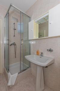 a bathroom with a sink and a glass shower at Apartmani Pilaš in Dramalj +91 photos