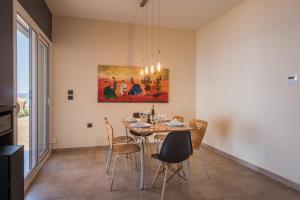 une salle à manger avec une table et des chaises dans l'établissement Blue Horizon Villas with Private Pool & Sea View, à Plateies