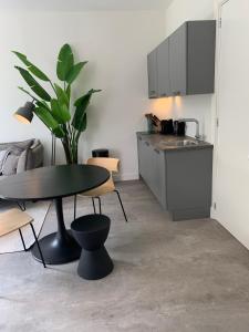 a living room with a table and a kitchen at Utrecht City Apartments - Maliesingel in Utrecht