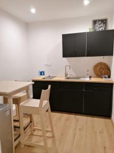 a kitchen with a table and a sink and a counter at Apartment Dubnica Prejta in Dubnica nad Váhom