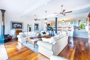 a living room filled with furniture and a fire place at Avocado Sunset Bed & Breakfast in Mount Tamborine