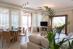 a living room with a couch and a table at Asteria Villas in Meganisi