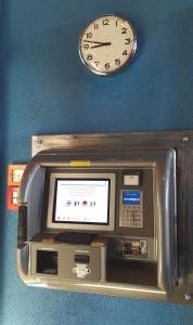 an electronic machine with a clock on a wall at MOTEL ARBOTEL 24h self check-in in Friesach
