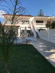 a white house with a patio and a lawn at Vivienda vacacional Josver in Benicàssim