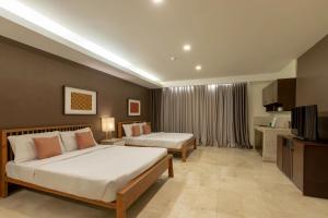 Postel nebo postele na pokoji v ubytování Selah Garden Hotel Manila + 32 fotografií