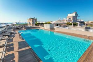 a large swimming pool on the roof of a building at Hotel Principe Palace in Lido di Jesolo