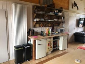 a kitchen with white cabinets and a counter top at Alexanderhaus in Mellensee