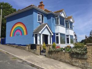 a house with a rainbow painted on the side of it at Southcroft in Bridport